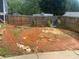 Backyard with red clay earth, stone edging, and some rock features at 6701 Knollwood Cir, Douglasville, GA 30135