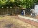 Backyard view featuring a wooden fence, some construction materials, and a grass lawn at 6701 Knollwood Cir, Douglasville, GA 30135