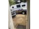 View of the backyard through an open door, with a trailer and car parked outside at 6701 Knollwood Cir, Douglasville, GA 30135