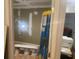 View into unfinished basement with drywall repair, ladder, paint, and storage visible at 6701 Knollwood Cir, Douglasville, GA 30135