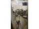 View of a cluttered basement area with a table, television, bicycle, and assorted items at 6701 Knollwood Cir, Douglasville, GA 30135