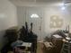 View of an unfinished basement area with a door, unorganized items, chairs, and paint buckets at 6701 Knollwood Cir, Douglasville, GA 30135