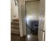 View of the basement stairway with carpeted steps and a door leading to the basement at 6701 Knollwood Cir, Douglasville, GA 30135