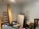 View of an unfinished basement area with ladders, storage units and a pile of assorted items at 6701 Knollwood Cir, Douglasville, GA 30135