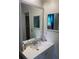 Bathroom vanity featuring white cabinets and a large framed mirror reflecting the space at 6701 Knollwood Cir, Douglasville, GA 30135