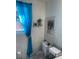 Bright bathroom featuring a toilet with a window and sheer blue curtains at 6701 Knollwood Cir, Douglasville, GA 30135