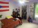 Cozy bedroom features a bed, desk, and closet space at 6701 Knollwood Cir, Douglasville, GA 30135