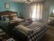 Well-lit bedroom with two beds and bright accents at 6701 Knollwood Cir, Douglasville, GA 30135