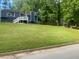 View of the home's front exterior with well-manicured lawn, showcasing its curb appeal at 6701 Knollwood Cir, Douglasville, GA 30135