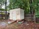 Backyard shed being constructed with wood paneling and a sloped ramp for easy access at 6701 Knollwood Cir, Douglasville, GA 30135