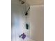 Shower and tub combo with white tiling and built in shelving at 6701 Knollwood Cir, Douglasville, GA 30135