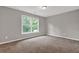 Bedroom with neutral walls and carpet flooring, large window with view at 1707 Taylor Ave, Atlanta, GA 30344