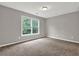 Bright bedroom featuring plush carpeting and a large window overlooking greenery at 1707 Taylor Ave, Atlanta, GA 30344