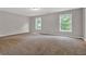 Expansive bedroom with plush carpeting and natural light from two windows at 1707 Taylor Ave, Atlanta, GA 30344