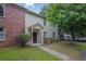 Charming home with a brick accent wall, light siding, well-manicured bushes, and a sidewalk leading to the front door at 1707 Taylor Ave, Atlanta, GA 30344
