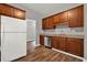 The Kitchen boasts stainless appliances, wooden cabinets, and wood floors at 1707 Taylor Ave, Atlanta, GA 30344