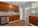 Charming kitchen features wood floors, wood cabinets, and stainless steel dishwasher at 1707 Taylor Ave, Atlanta, GA 30344