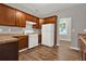 Well-lit kitchen with a gas range, stainless steel refrigerator and wooden cabinets at 1707 Taylor Ave, Atlanta, GA 30344