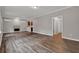 Open-concept living room featuring wood floors, fireplace, and an open view of the kitchen at 1707 Taylor Ave, Atlanta, GA 30344