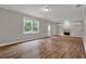 Spacious living room with light gray walls, wood floors, a fireplace, and a large window at 1707 Taylor Ave, Atlanta, GA 30344
