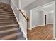 Carpeted staircase with wooden banister leads to the second floor at 1707 Taylor Ave, Atlanta, GA 30344