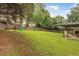 Spacious backyard with mature trees, playground, and patio area at 2205 Waters Ferry Dr, Lawrenceville, GA 30043