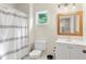Clean bathroom with striped shower curtain, white toilet, and modern sink at 2205 Waters Ferry Dr, Lawrenceville, GA 30043