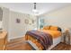 Comfortable bedroom with modern decor, hardwood floors, and a sunny window at 2205 Waters Ferry Dr, Lawrenceville, GA 30043