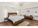 Tranquil main bedroom with hardwood floors, a king-size bed, and a cozy sitting area at 2205 Waters Ferry Dr, Lawrenceville, GA 30043