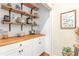 Charming pantry with butcher block countertop, white cabinets and open shelving, perfect for storage at 2205 Waters Ferry Dr, Lawrenceville, GA 30043
