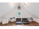 Attic playroom with unique architectural details, round window, and cozy seating at 2205 Waters Ferry Dr, Lawrenceville, GA 30043