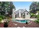 Lush backyard featuring a pool and a spa bordered by landscaping and greenery at 2714 Twin Leaf Trl, Marietta, GA 30062