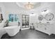 Modern bathroom features a sleek soaking tub, stylish storage cabinet, and contemporary design at 2714 Twin Leaf Trl, Marietta, GA 30062