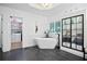 Modern bathroom features a sleek soaking tub, stylish storage cabinet, and contemporary design at 2714 Twin Leaf Trl, Marietta, GA 30062