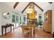 Charming dining area with beamed ceilings, stone fireplace, and views of the outdoor pool at 2714 Twin Leaf Trl, Marietta, GA 30062