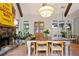 Dining area featuring a stone fireplace, beamed ceilings and views to the outdoor pool area at 2714 Twin Leaf Trl, Marietta, GA 30062