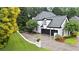 Rear exterior of home showcasing a 2-car garage, well-maintained yard, and mature trees at 2714 Twin Leaf Trl, Marietta, GA 30062