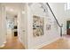 Foyer view featuring light hardwood floors, shiplap accent wall, and open entryway at 2714 Twin Leaf Trl, Marietta, GA 30062