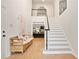 Bright and inviting foyer with hardwood floors, staircase, and bench seating at 2714 Twin Leaf Trl, Marietta, GA 30062
