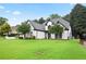 Well-manicured front yard with lush green lawn and beautiful landscaping surrounding a charming white home at 2714 Twin Leaf Trl, Marietta, GA 30062