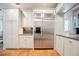 Modern kitchen featuring stainless steel refrigerator, white cabinets, and earth-toned tile flooring at 2714 Twin Leaf Trl, Marietta, GA 30062
