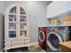 Well-equipped laundry room with slate flooring, storage cabinet and front-loading washer and dryer at 2714 Twin Leaf Trl, Marietta, GA 30062