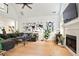 Inviting living room featuring a cozy sectional, hardwood floors, and a fireplace with a television above at 2714 Twin Leaf Trl, Marietta, GA 30062