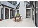 Concrete patio with black framed windows and door, and an outdoor table and chairs at 2714 Twin Leaf Trl, Marietta, GA 30062