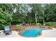 In-ground pool with a brick border and a stone-walled spa, set in a green backyard at 2714 Twin Leaf Trl, Marietta, GA 30062