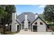 Charming home's rear exterior with a concrete patio, black trim, and a pristine yard at 2714 Twin Leaf Trl, Marietta, GA 30062