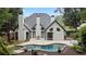 Gorgeous home's rear exterior showcasing the pool, patio, and well-manicured backyard at 2714 Twin Leaf Trl, Marietta, GA 30062