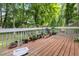 Inviting wood deck featuring a white railing adorned with potted plants and greenery, creating a tranquil outdoor space at 3500 Stillwood Dr, Snellville, GA 30039
