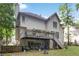 Back of house featuring a deck, lawn, and mature trees at 3500 Stillwood Dr, Snellville, GA 30039