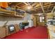 Unfinished basement with concrete walls, red floors, and a window for natural light at 3500 Stillwood Dr, Snellville, GA 30039